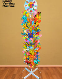 Colorful candy tree with various toys on a stand against a brown wall.
