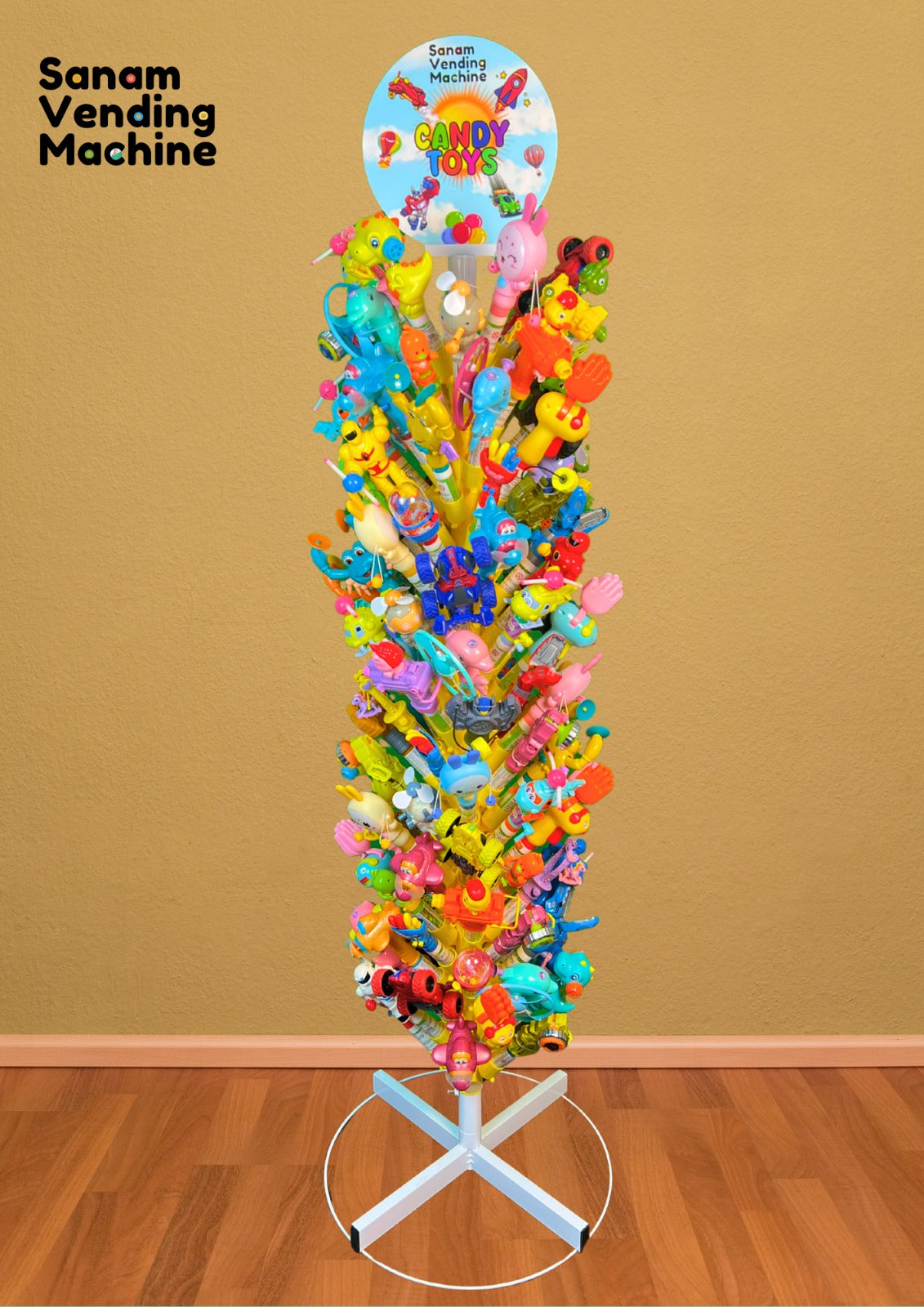 Colorful candy tree with various toys on a stand against a brown wall.